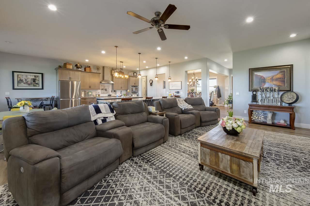 Living room featuring recessed lighting, a chandelier, wood finished floors, and ceiling fan