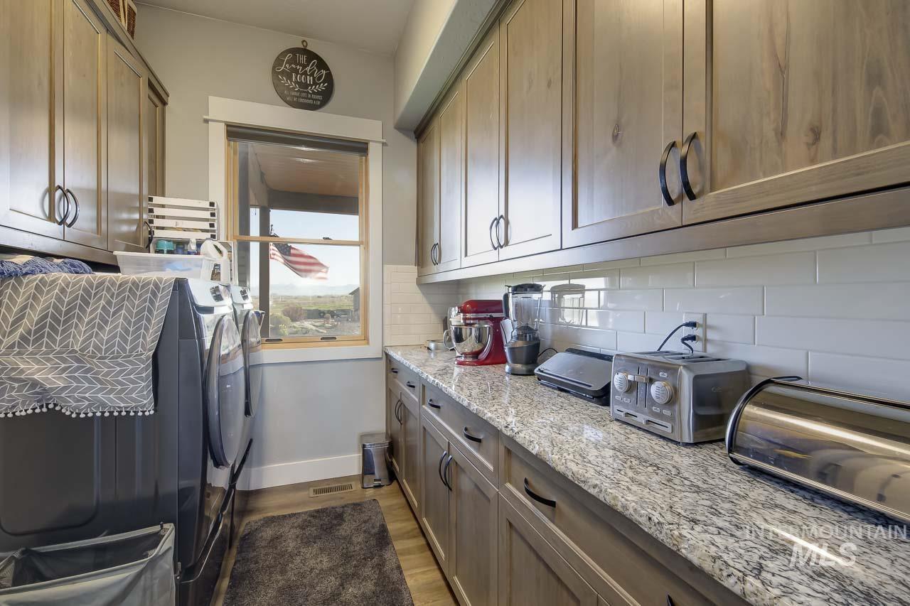 Laundry room featuring dark wood-style flooring and separate washer and dryer