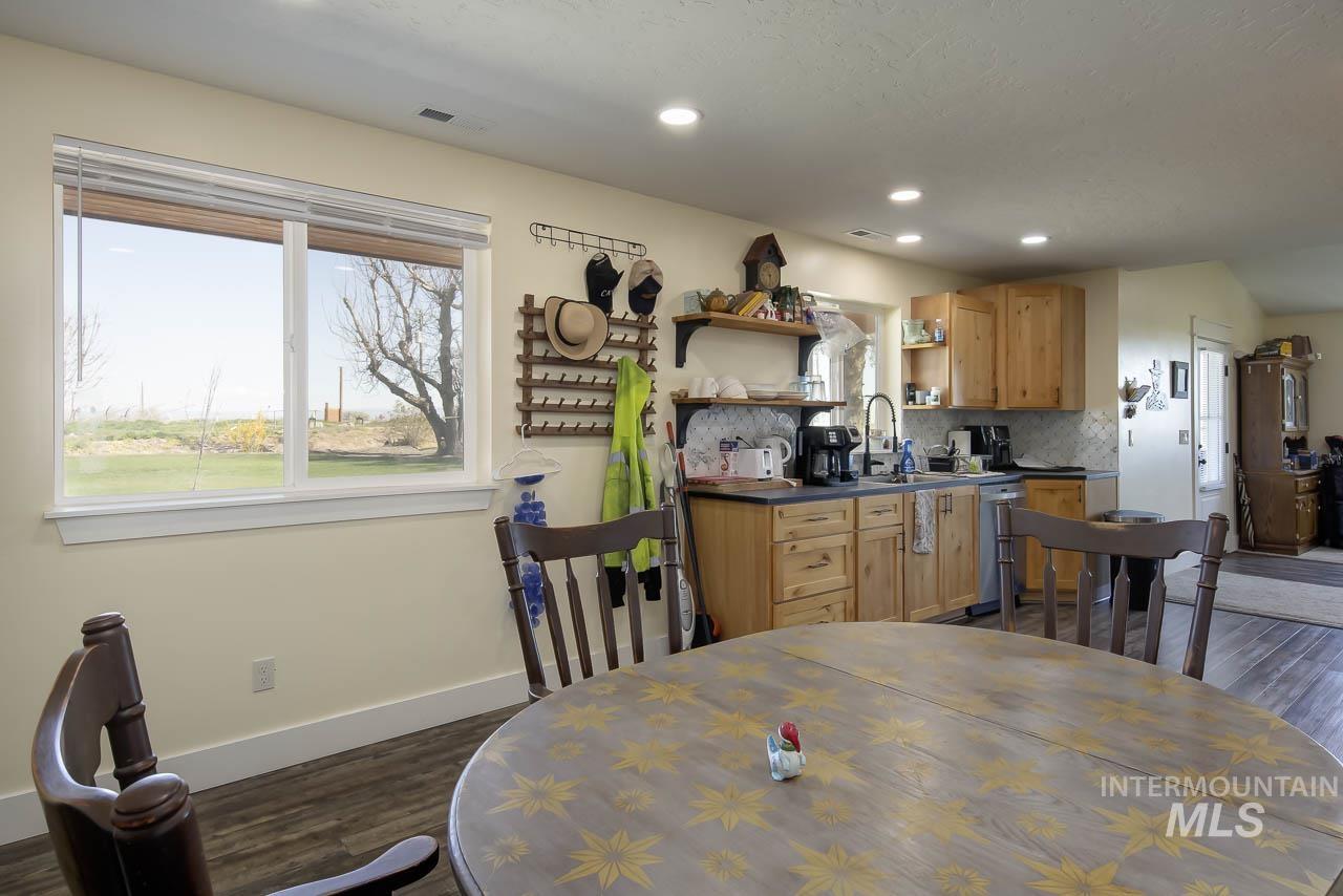 Dining area featuring healthy amount of natural light, dark wood-style floors, and recessed lighting