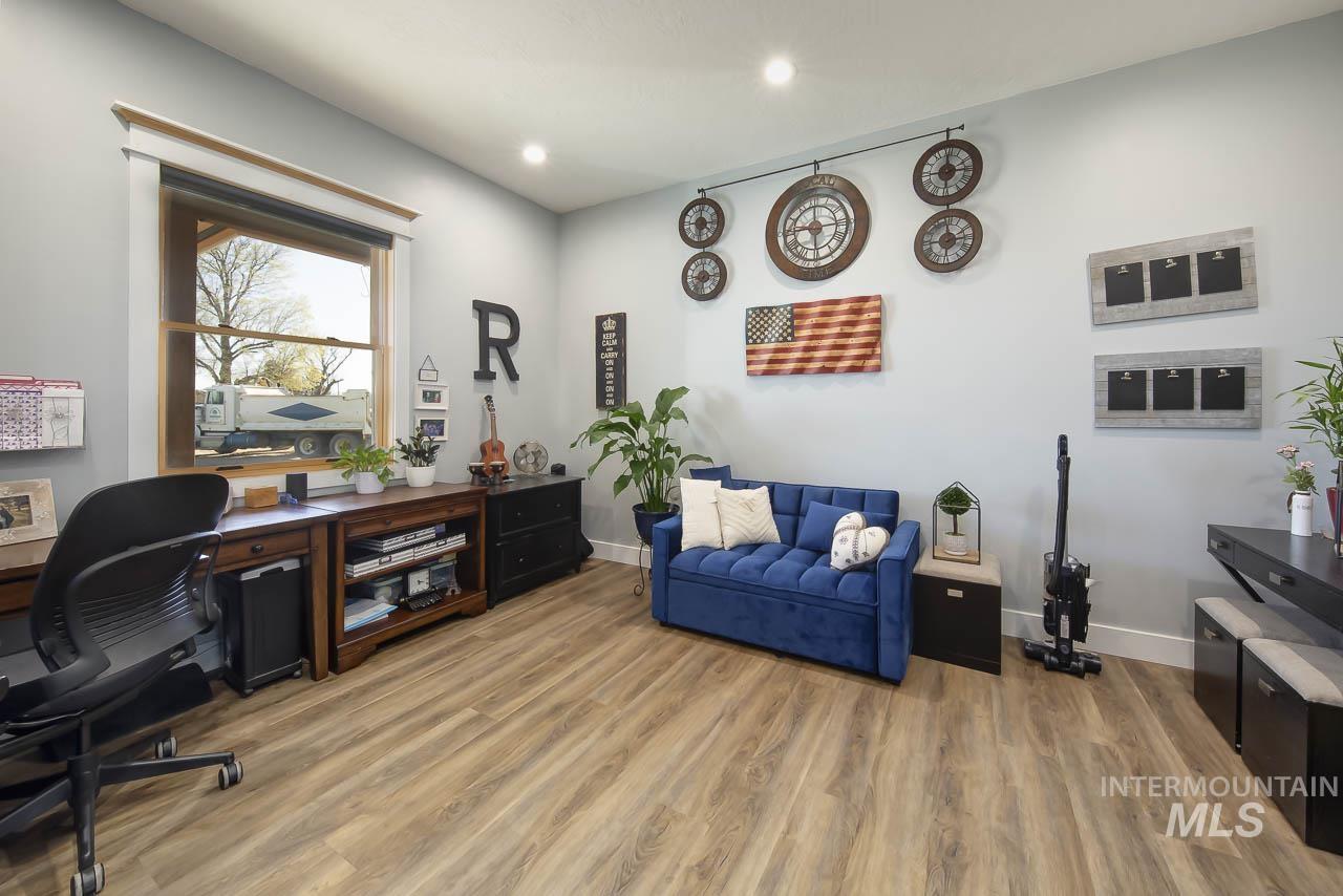 Home office featuring light wood-style floors and recessed lighting