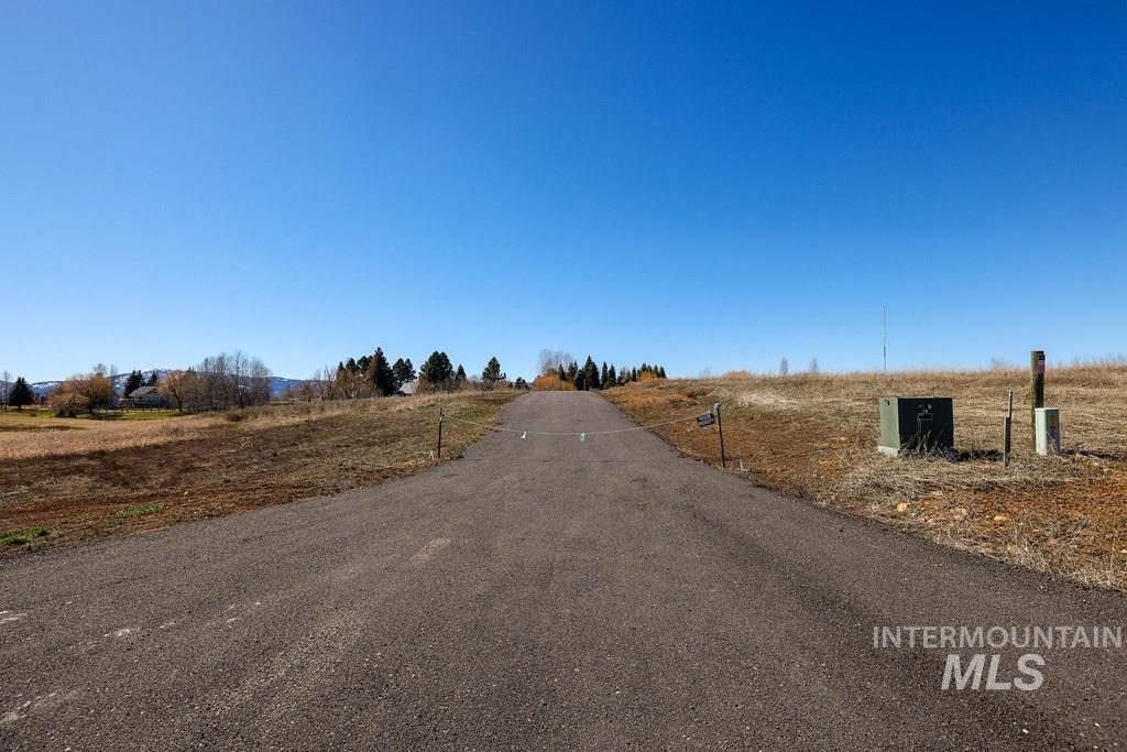 View of asphalt street featuring a view of rural / pastoral area