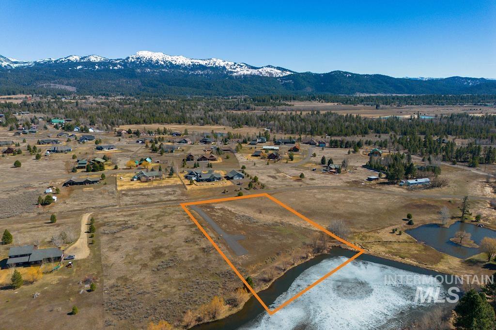 Aerial view of property's location with property parcel outlined and a water and mountain view