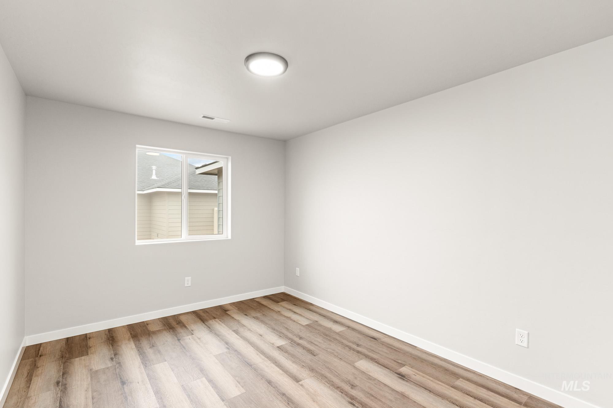Empty room featuring light wood-style flooring and baseboards