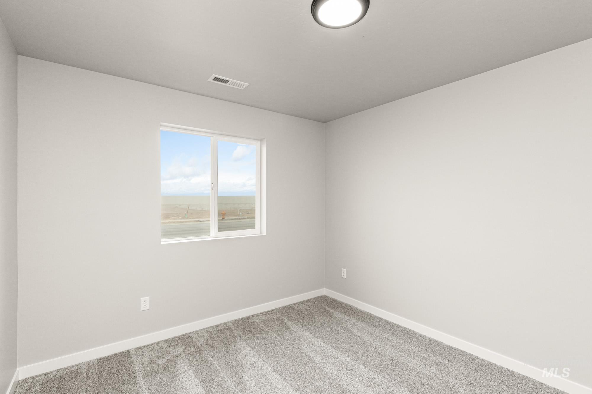 Unfurnished room with carpet flooring and baseboards