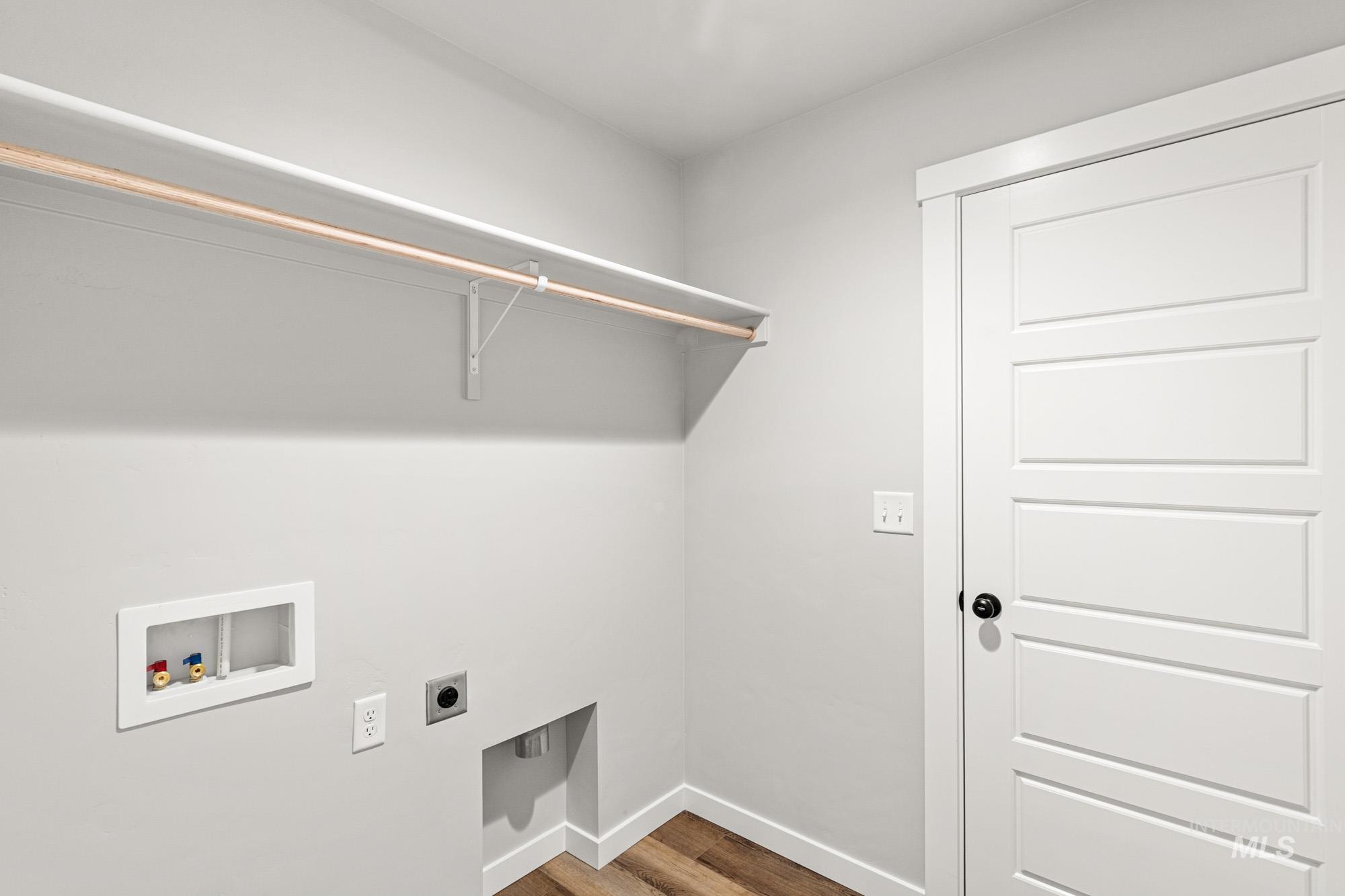 Laundry room featuring electric dryer hookup, wood finished floors, and washer hookup