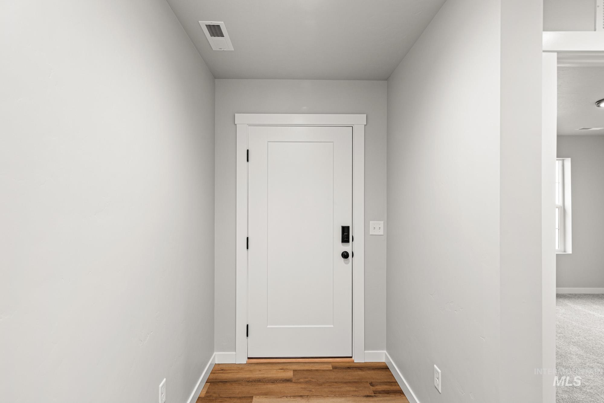 Entryway with baseboards and wood finished floors