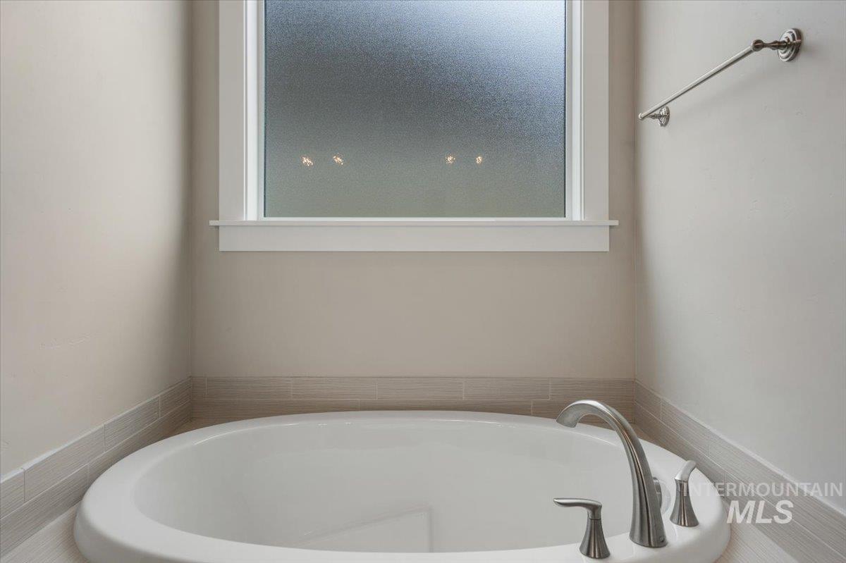 Full bathroom featuring a bath