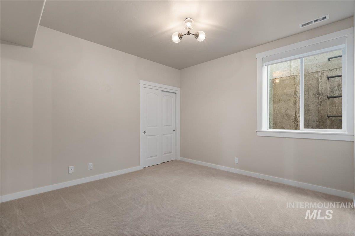 Unfurnished room featuring light colored carpet and baseboards
