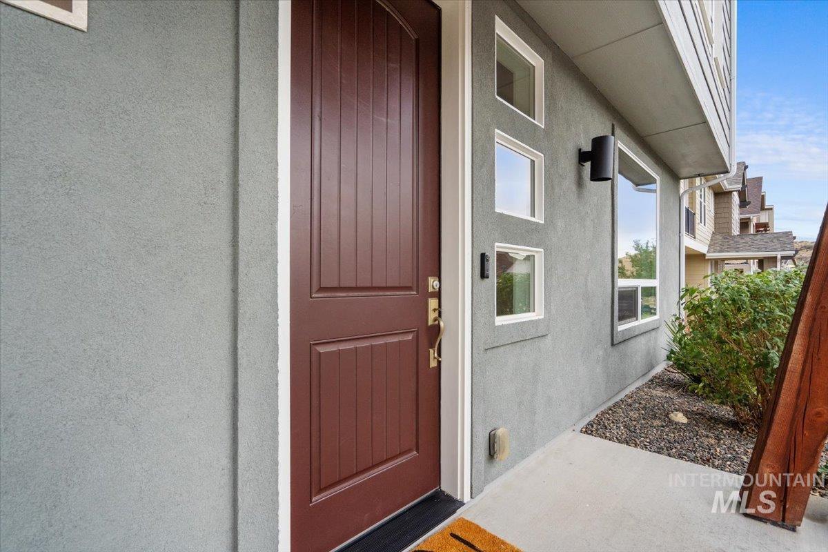 View of exterior entry featuring stucco siding