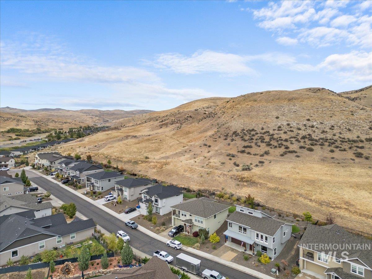 Aerial view of residential area featuring a mountainous background