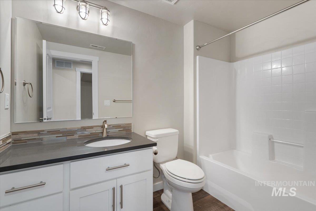 Bathroom featuring vanity and  shower combination