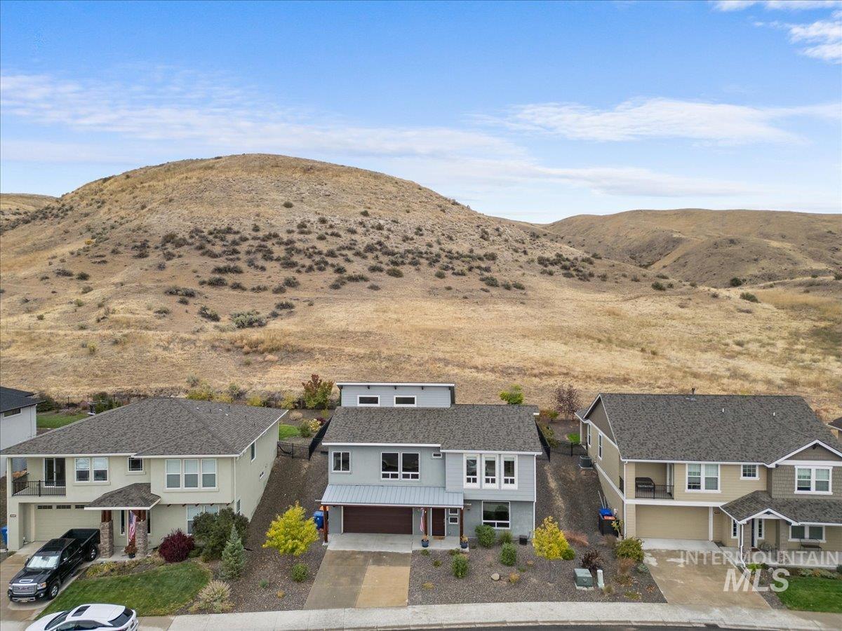 View of mountain backdrop featuring nearby suburban area