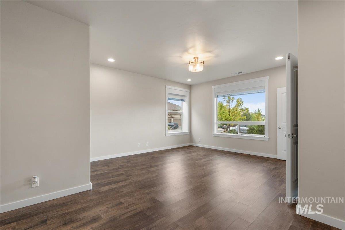 Unfurnished room featuring dark wood-style flooring and recessed lighting
