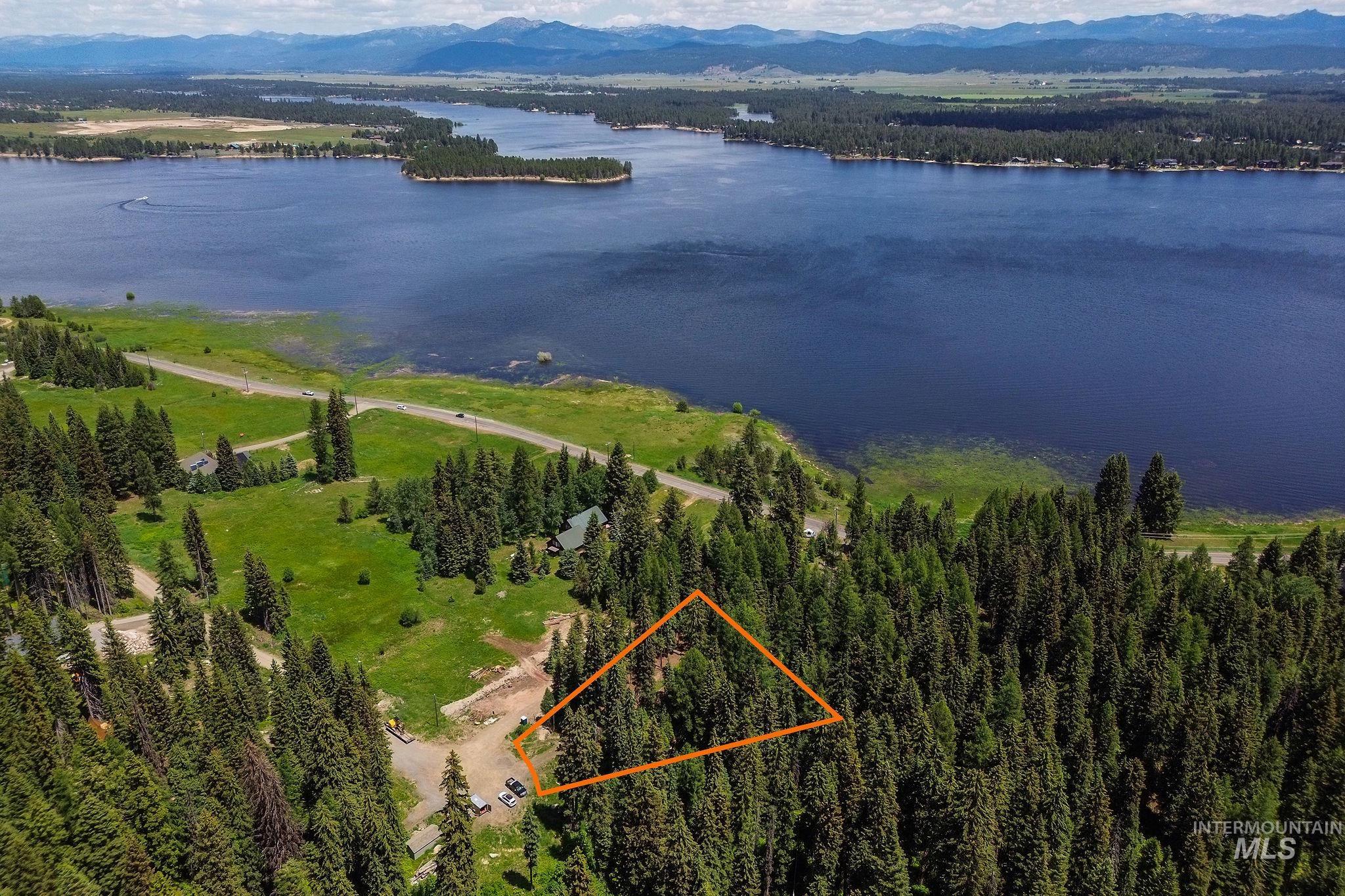 View of property location featuring a water and mountain view and property parcel outlined