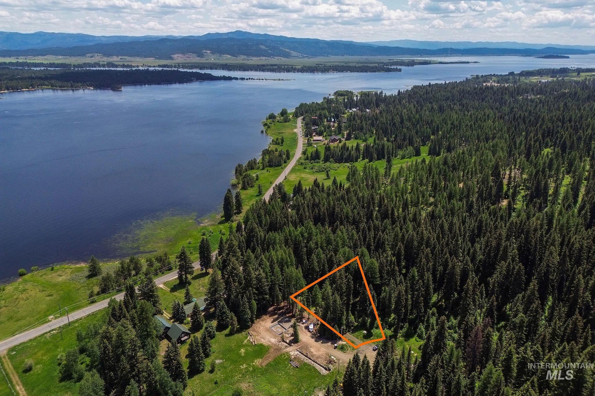 View of property location with a water and mountain view and property boundaries highlighted