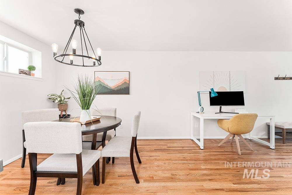 Dining area featuring light wood-style flooring and a chandelier