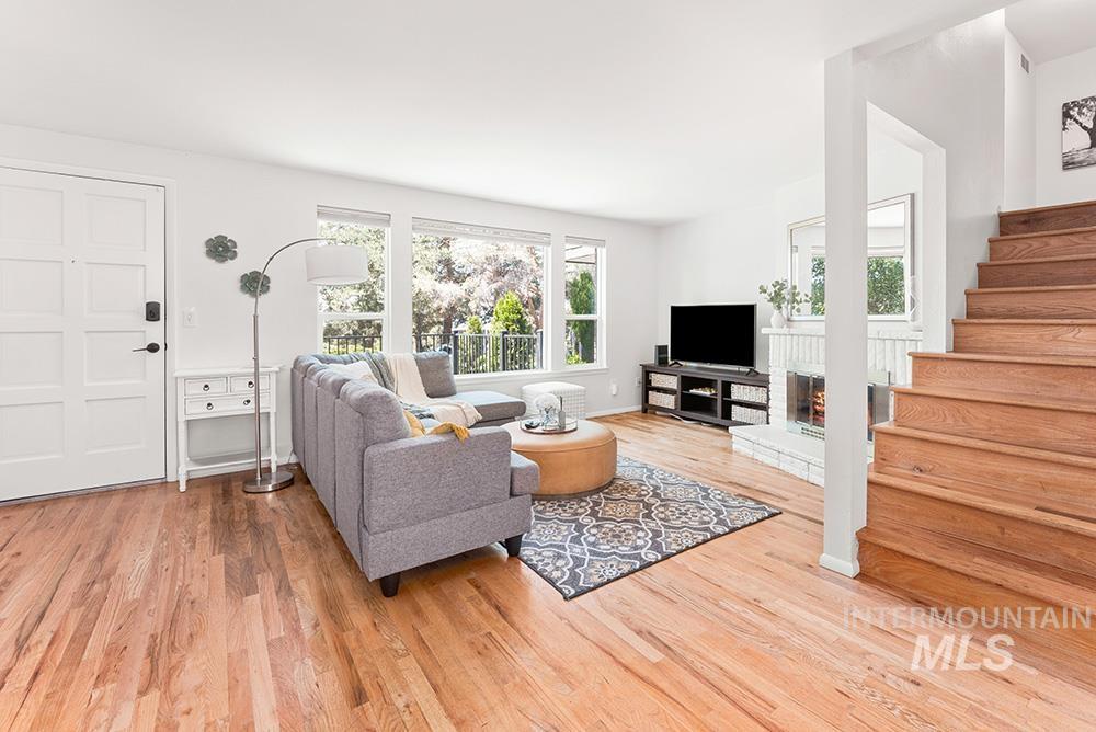 Living area with plenty of natural light, light wood-style flooring, and a fireplace