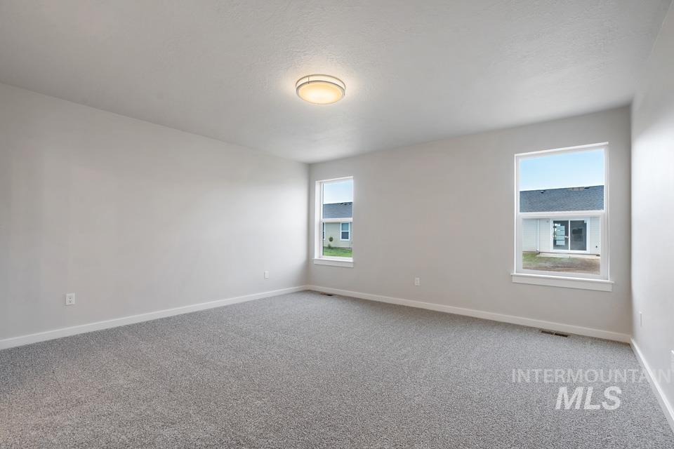 Carpeted empty room with baseboards