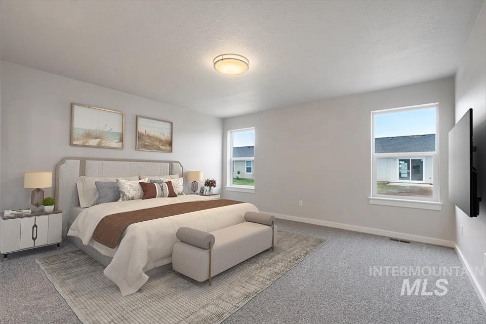 Carpeted bedroom featuring baseboards