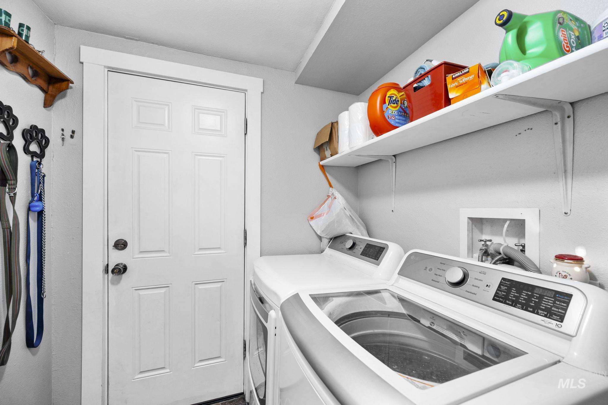Laundry area with washer and clothes dryer