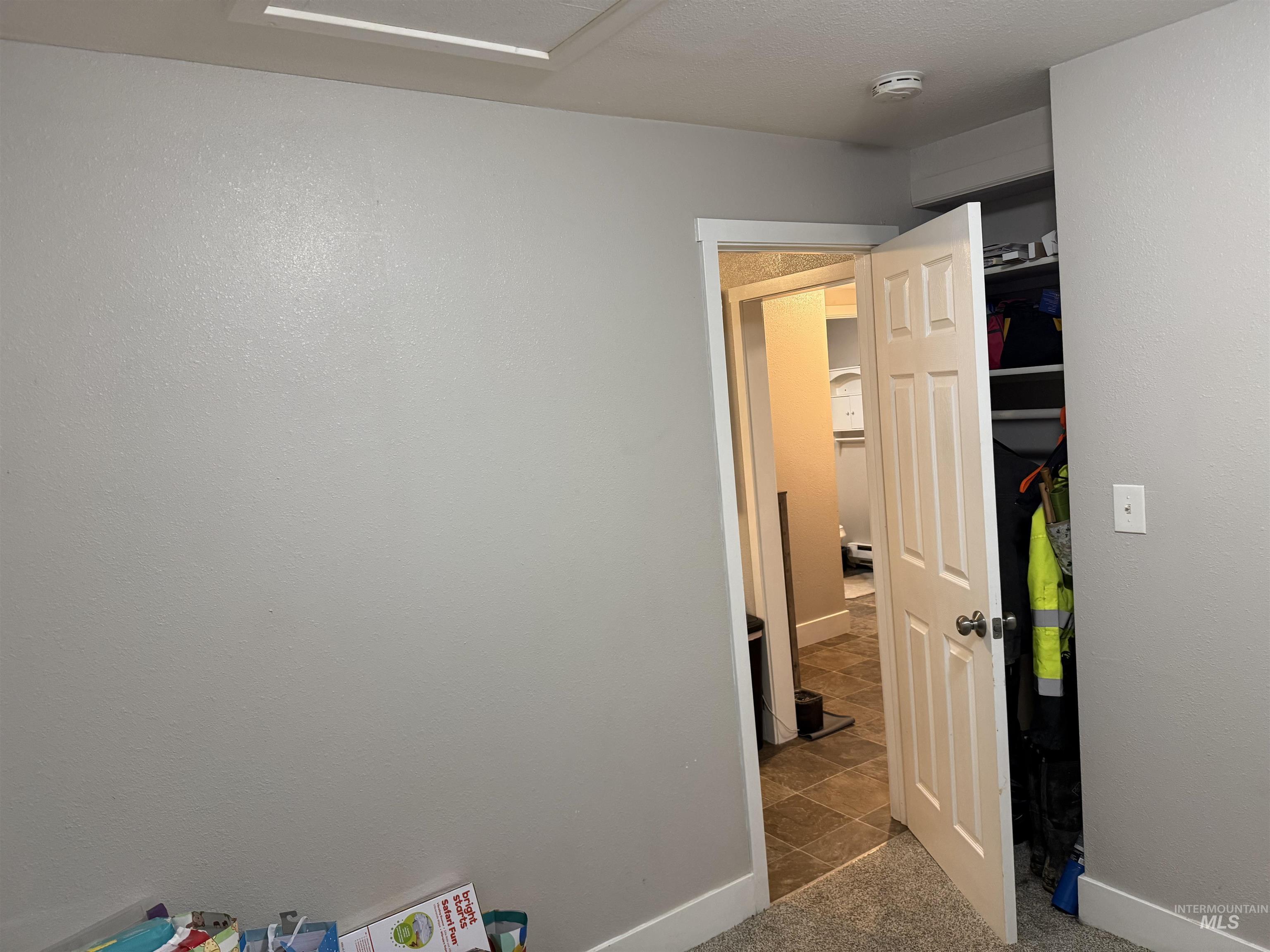 Bedroom featuring baseboards and dark colored carpet