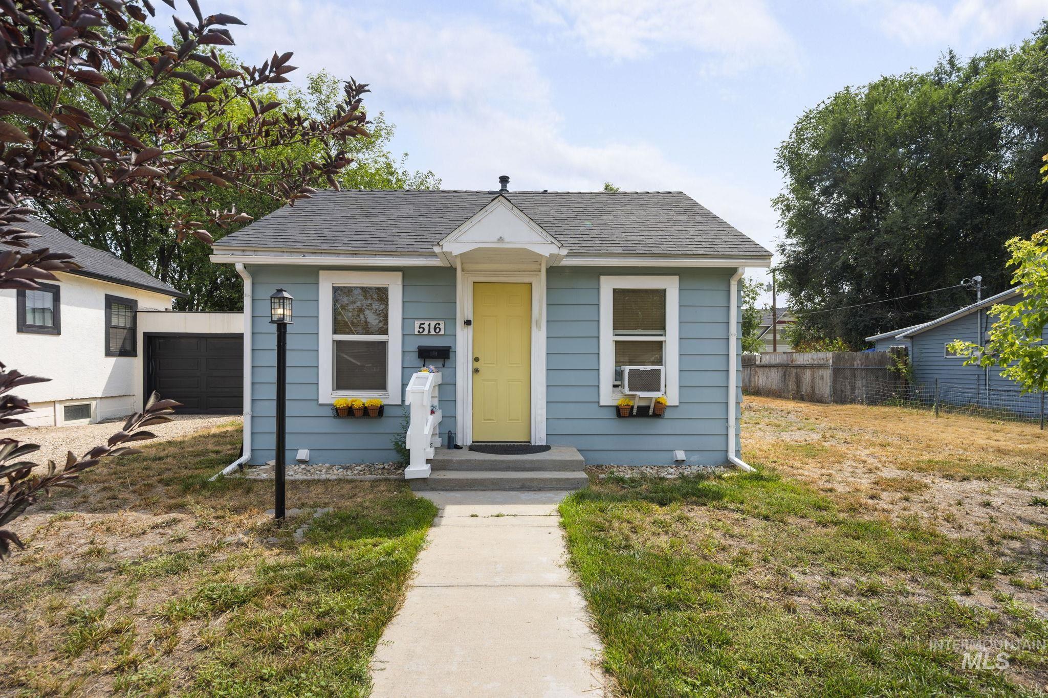 Bungalow-style home with a shingled roof