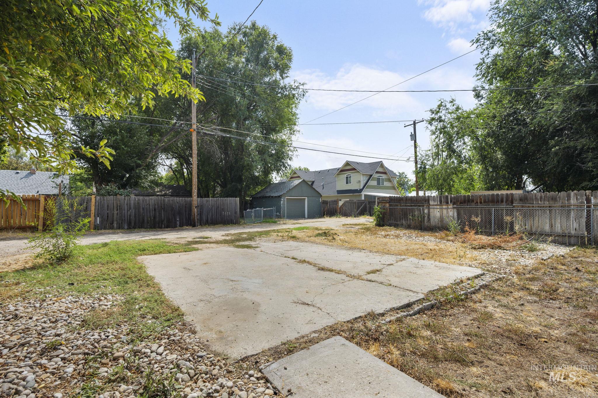 Fenced backyard featuring an outdoor structure