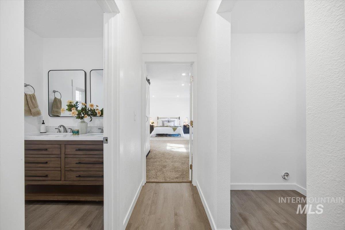 Hallway featuring baseboards and light wood-style floors