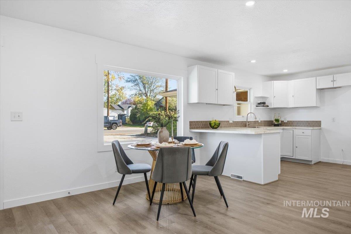 Dining room featuring light wood-type flooring and recessed lighting