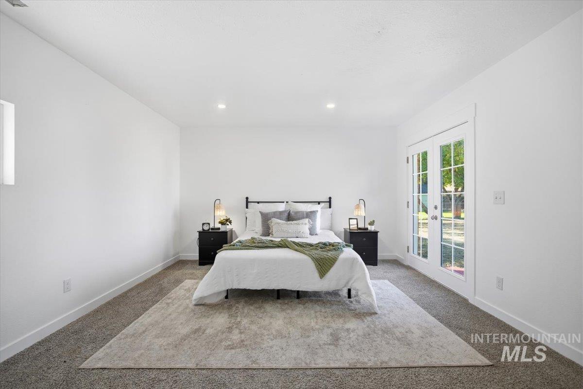 Carpeted bedroom with access to outside and recessed lighting