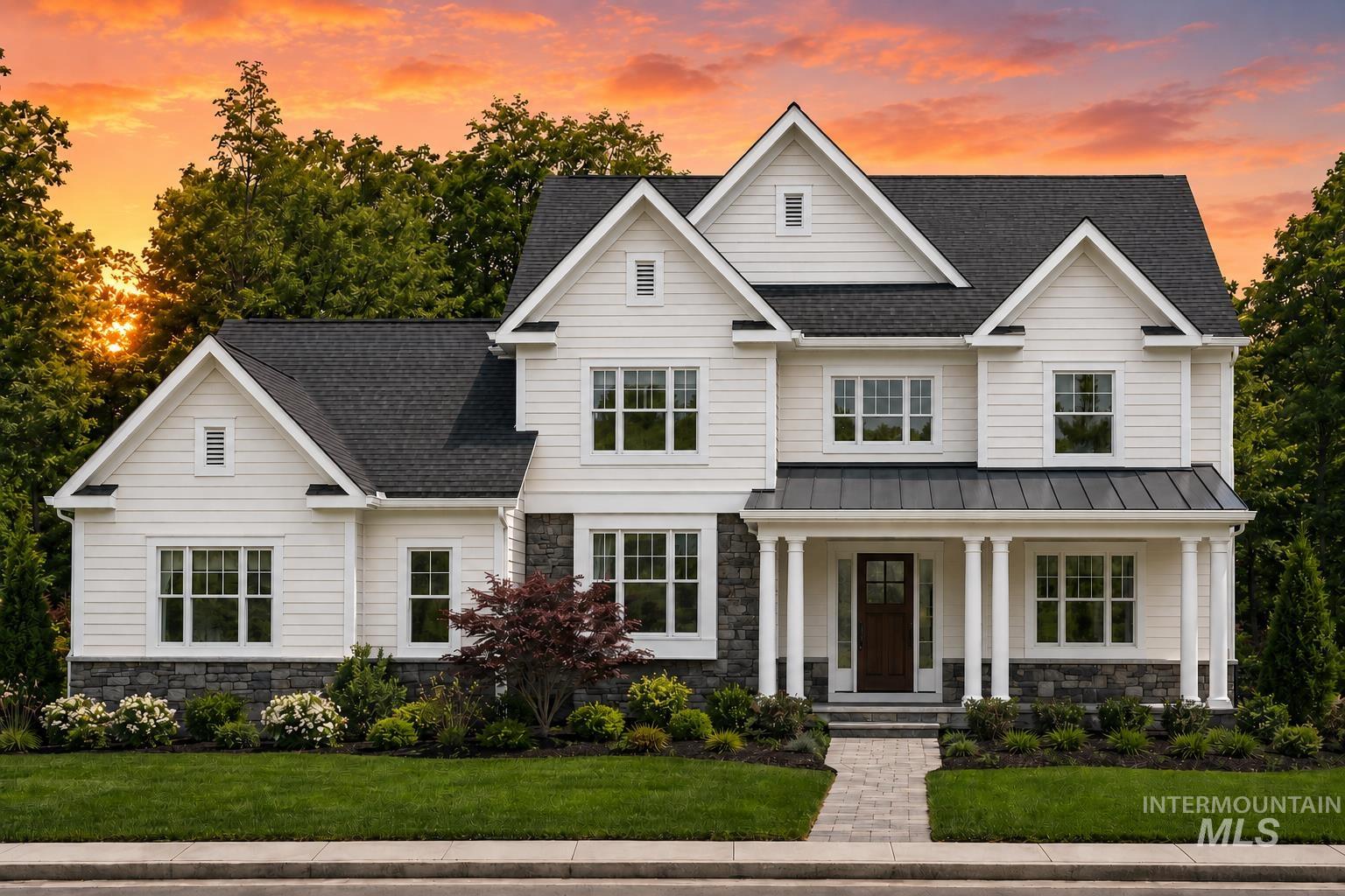 White siding exterior with dark stone accents, featuring a prominent covered porch supported by white columns