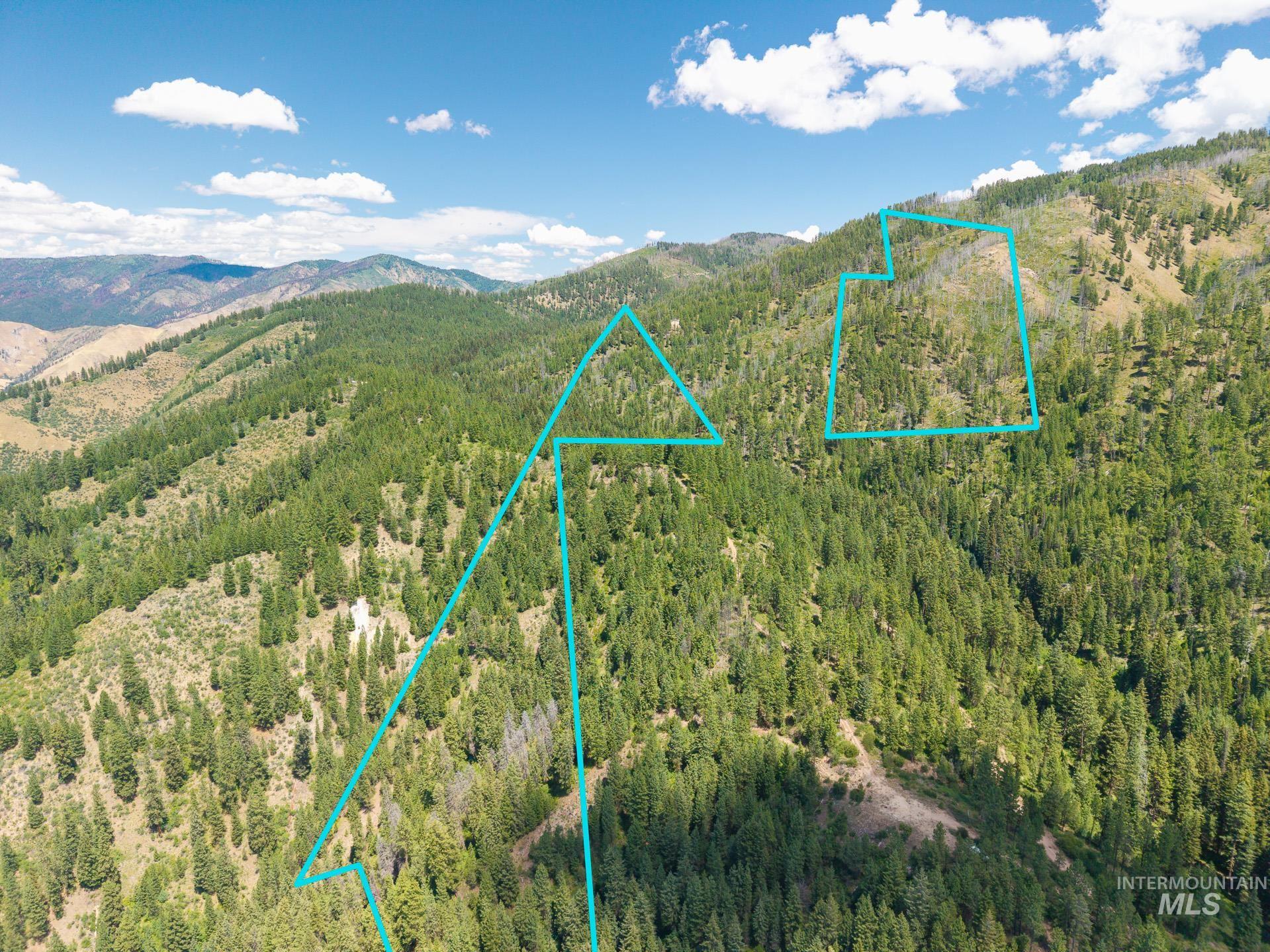View of property location with a mountain backdrop and property boundaries highlighted