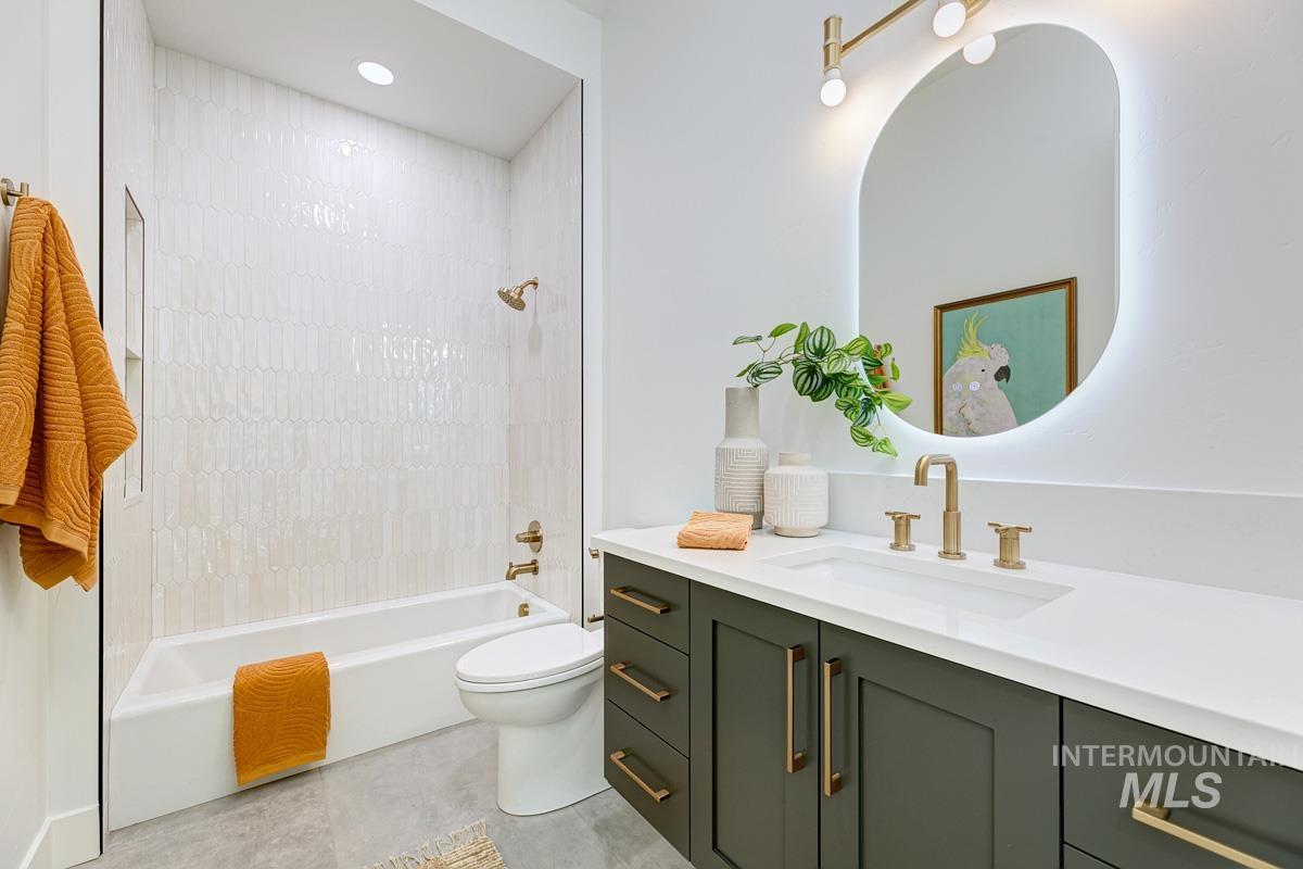 Full bath with  shower combination, vanity, and recessed lighting