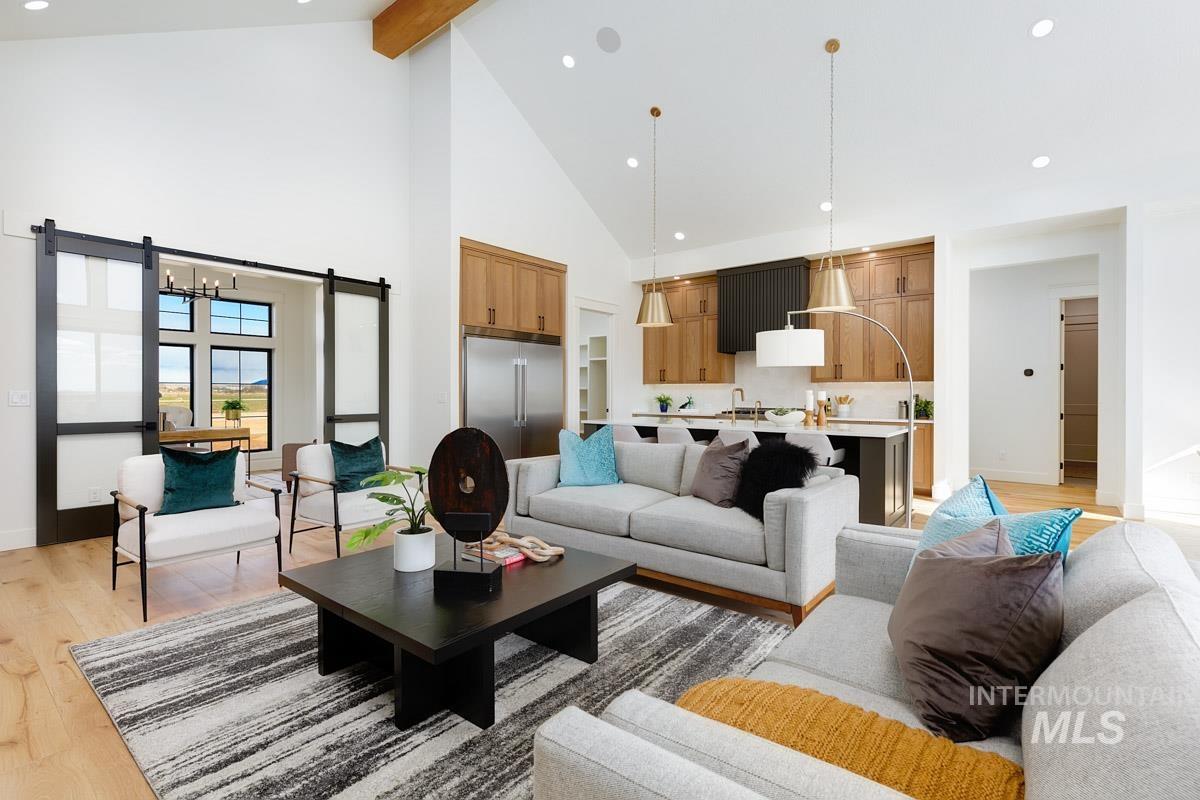 Living room featuring recessed lighting, light wood finished floors, beamed ceiling, and high vaulted ceiling