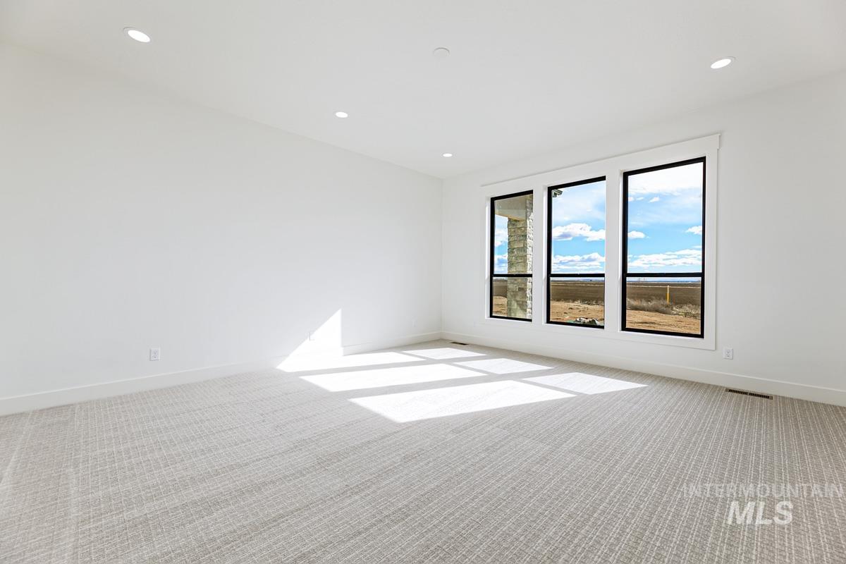 Spare room featuring carpet and recessed lighting