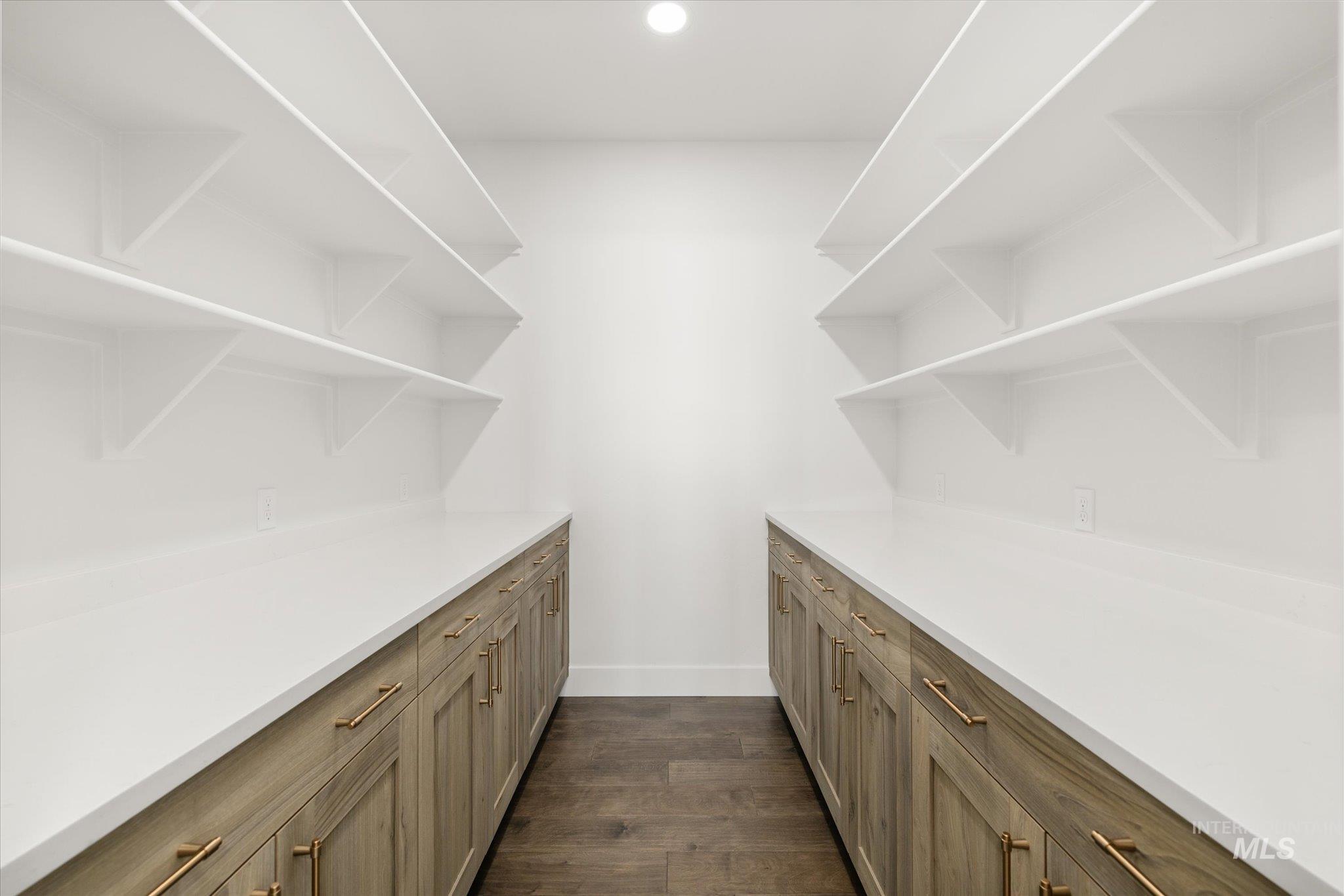 Bar area featuring open shelves, dark wood-style flooring, brown cabinets, and recessed lighting