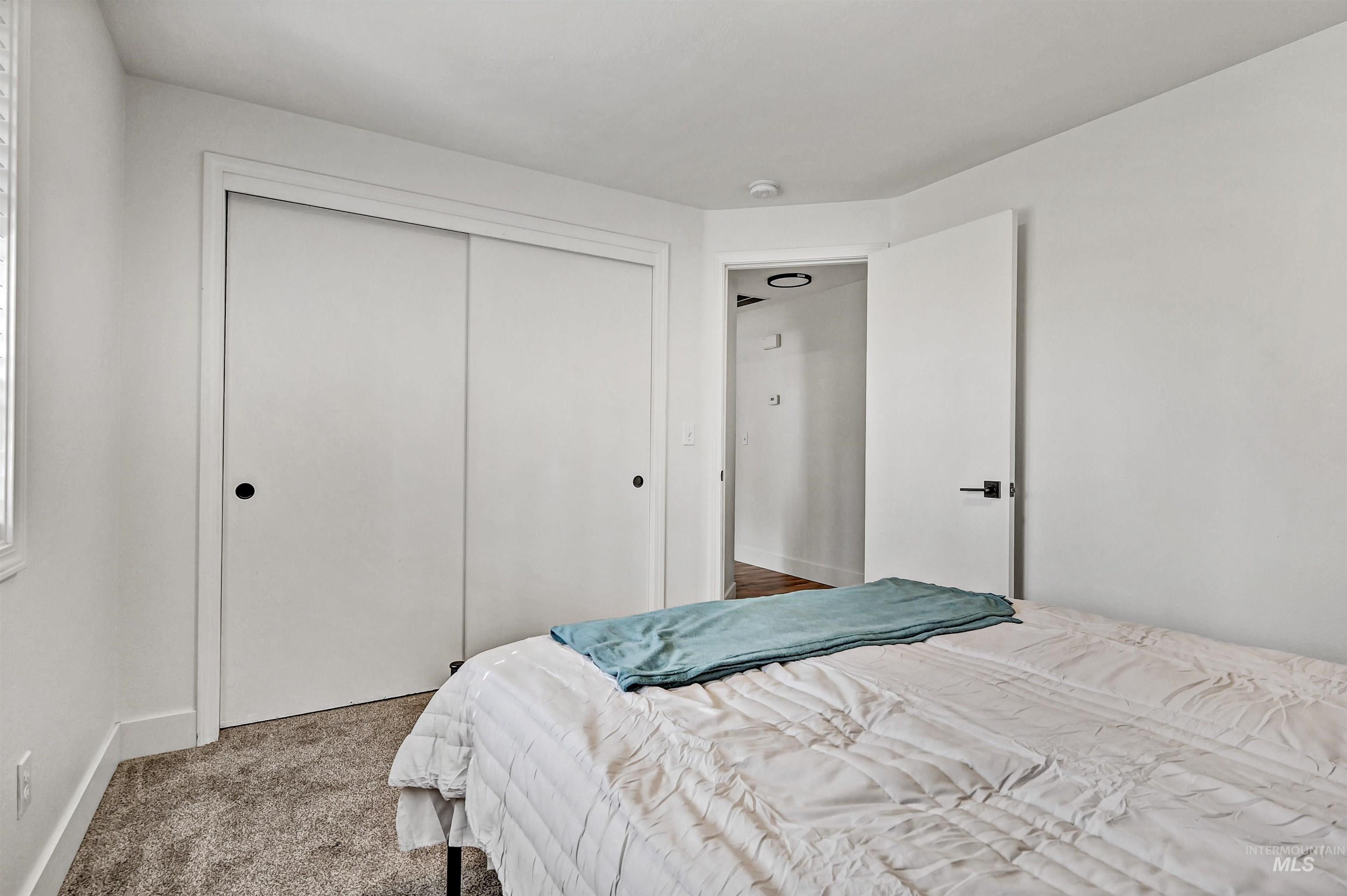 Bedroom with carpet and a closet