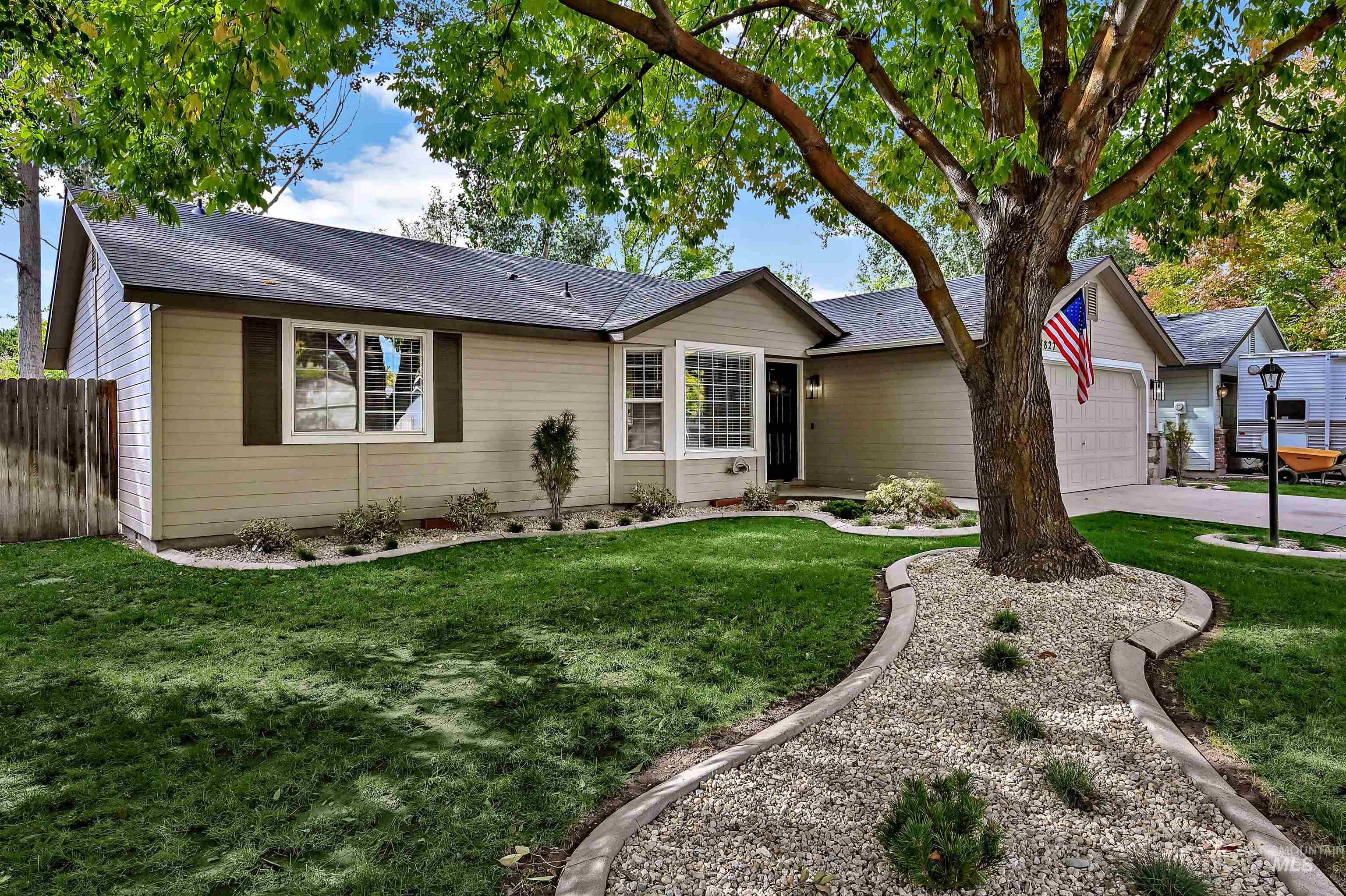 Ranch-style house featuring new and mature landscaping, an attached garage, and a brand new roof