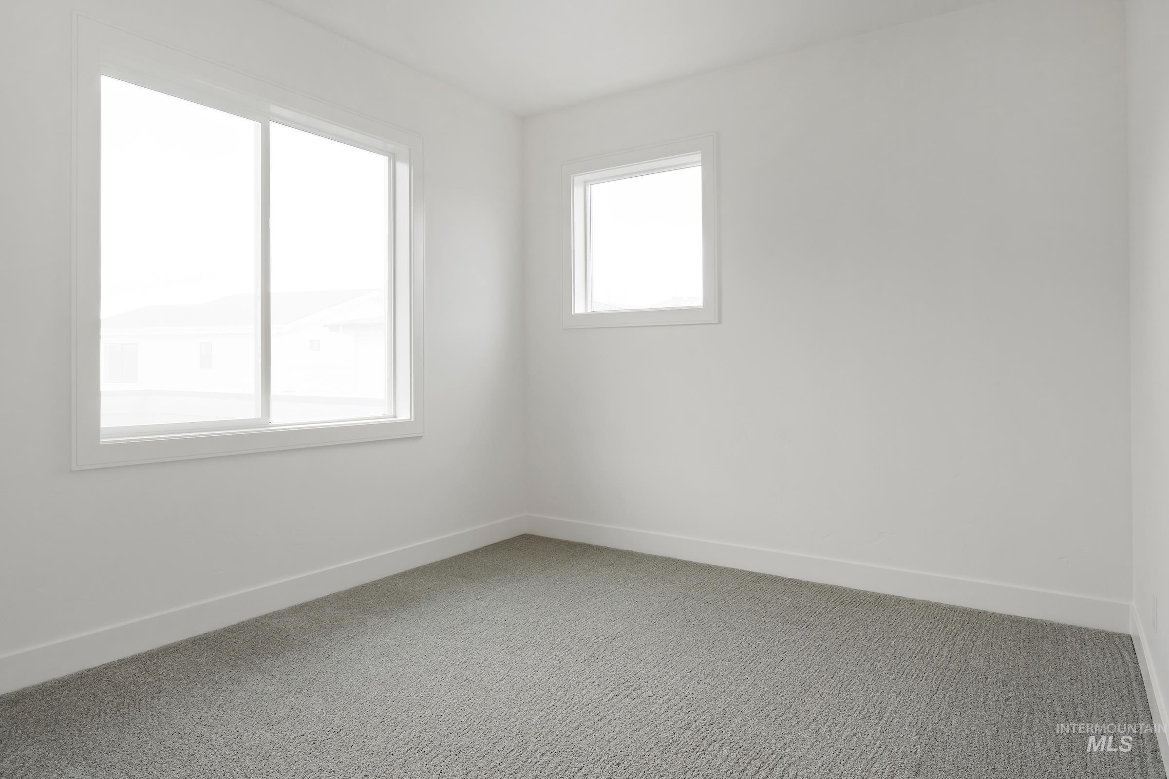 Spare room with baseboards and carpet floors