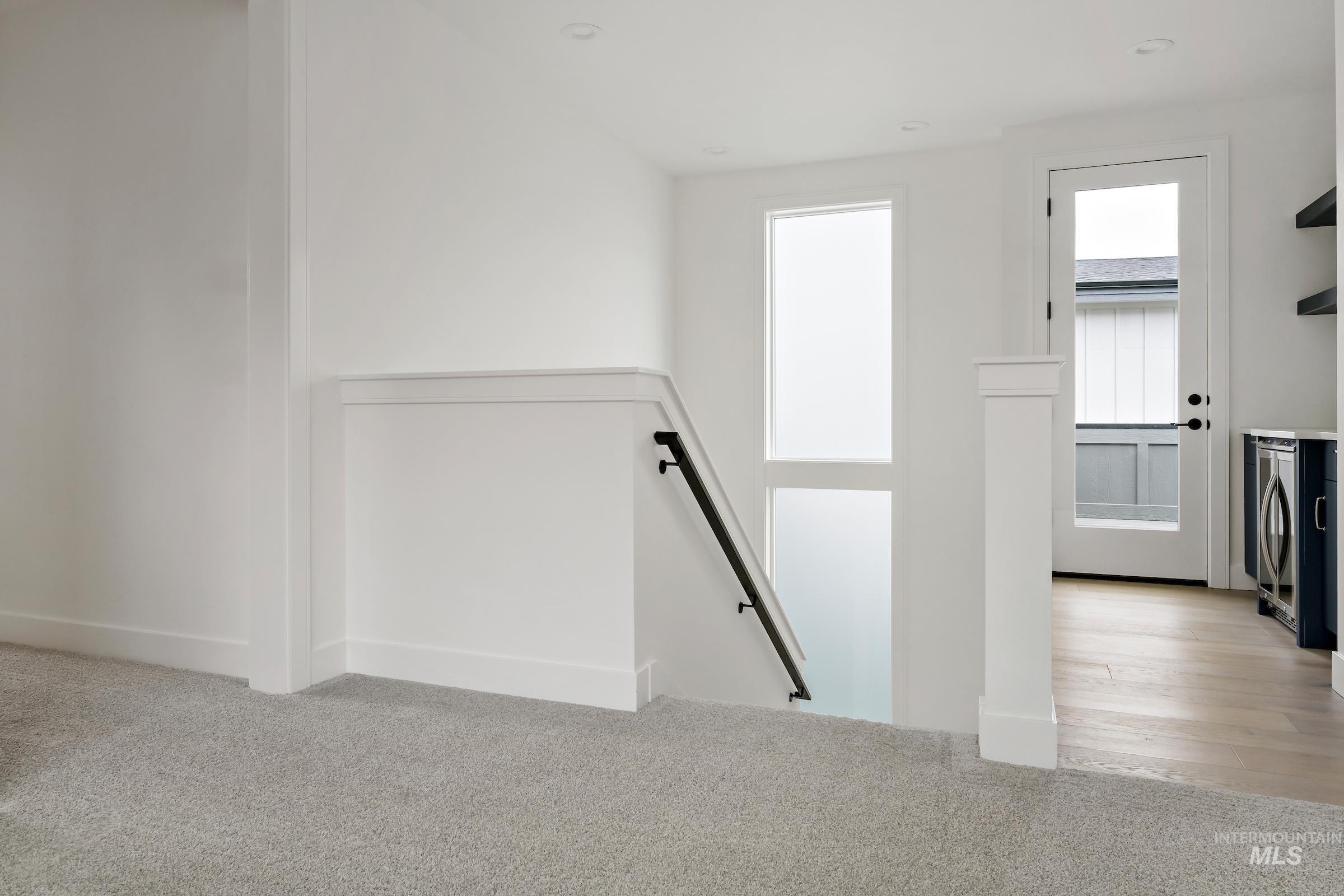 Stairway featuring carpet floors and washer and dryer