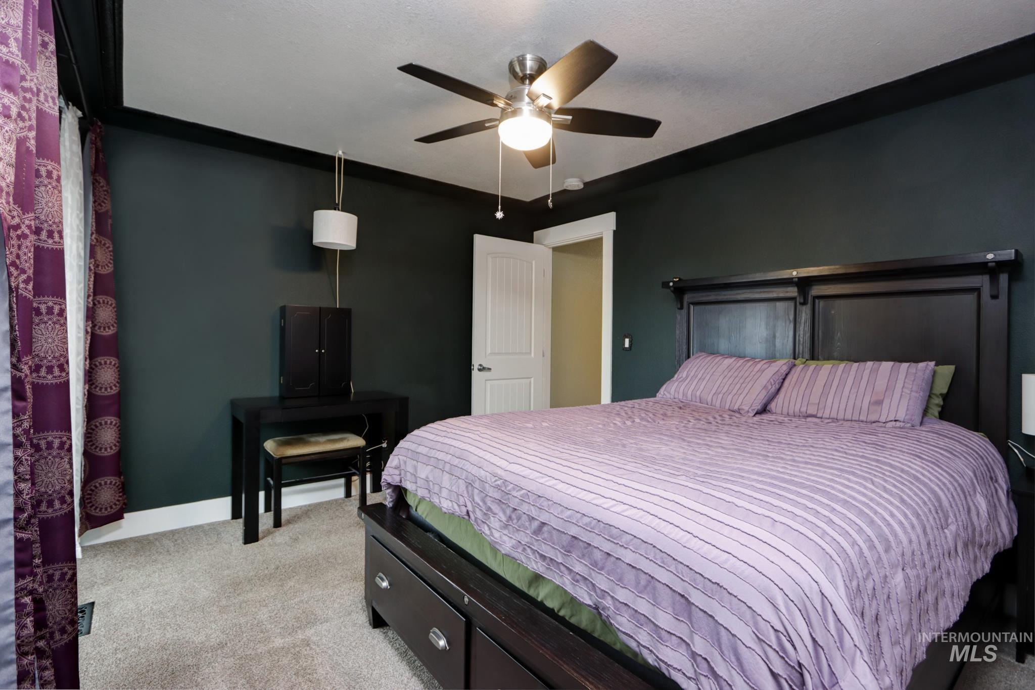 Bedroom with light carpet and ceiling fan