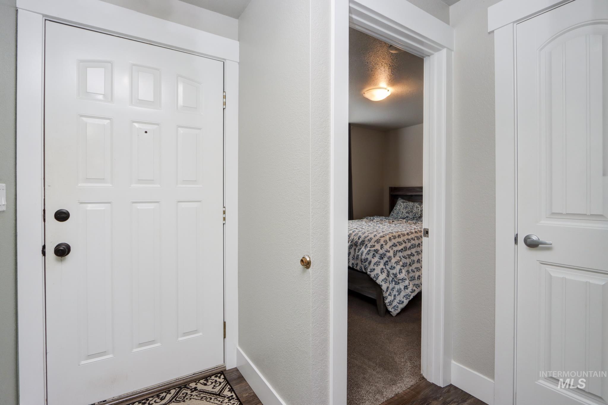 Hallway featuring dark wood-style floors