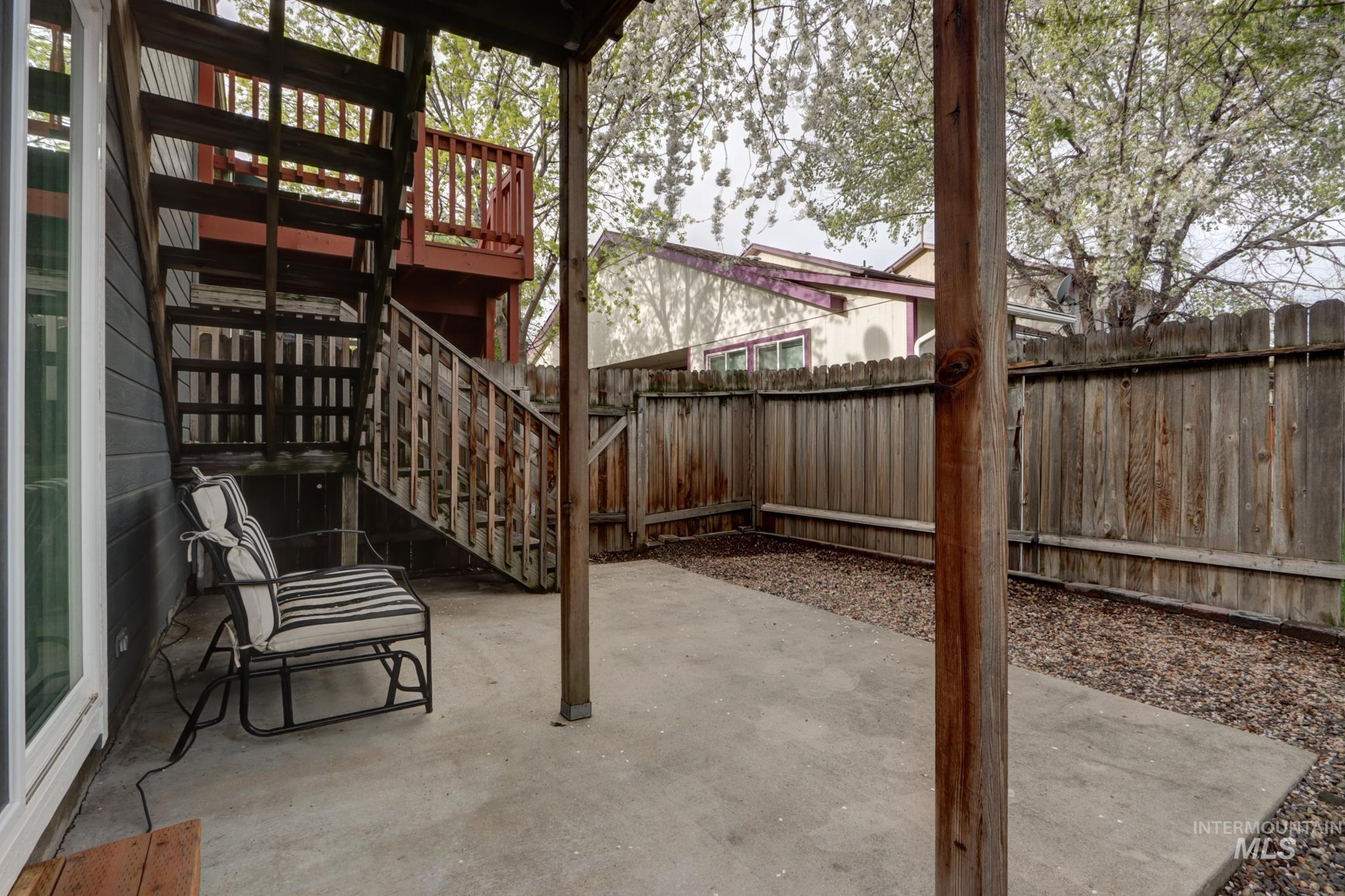 Fenced backyard featuring a patio and stairway
