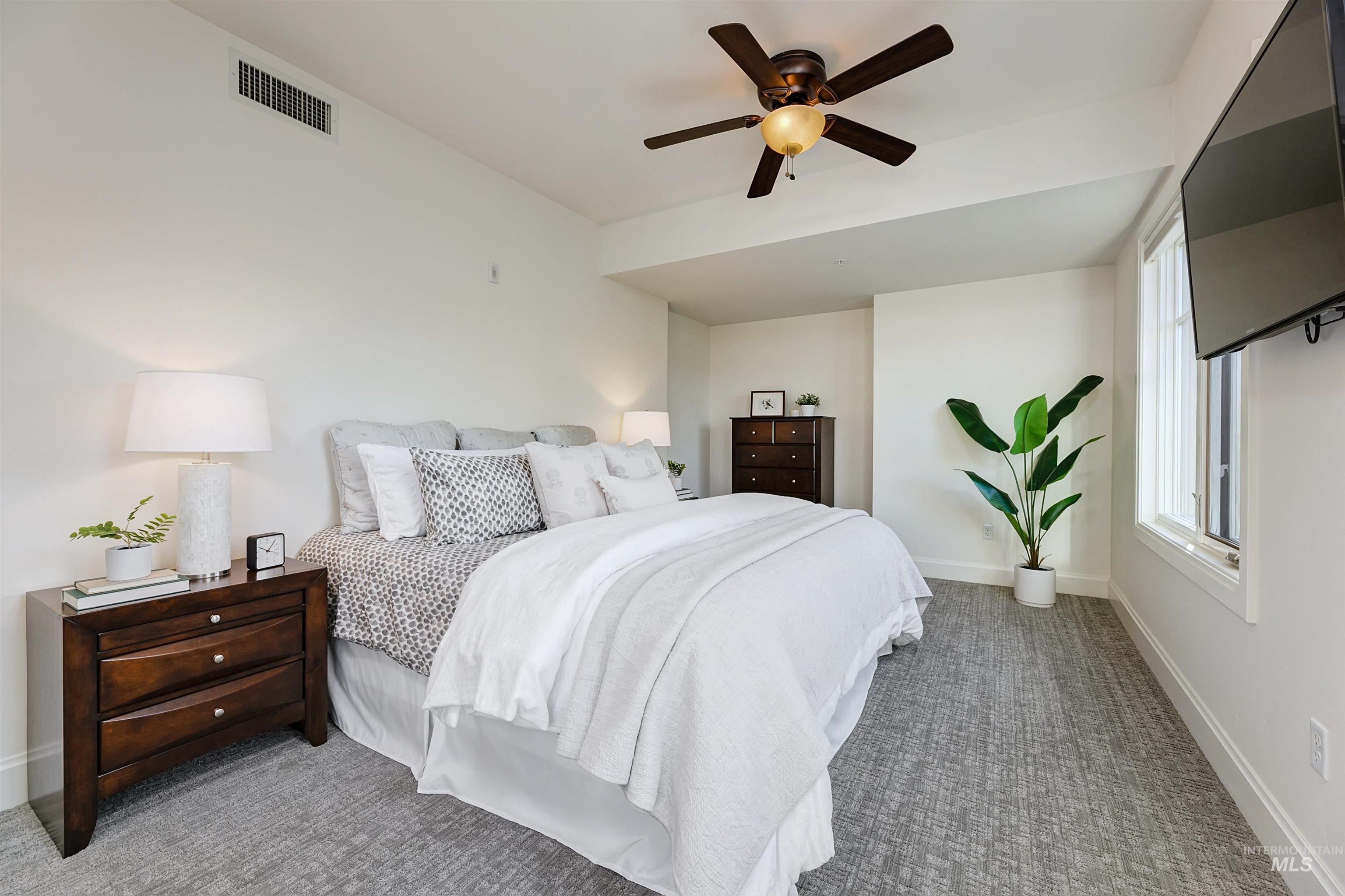 Bedroom with carpet flooring and a ceiling fan