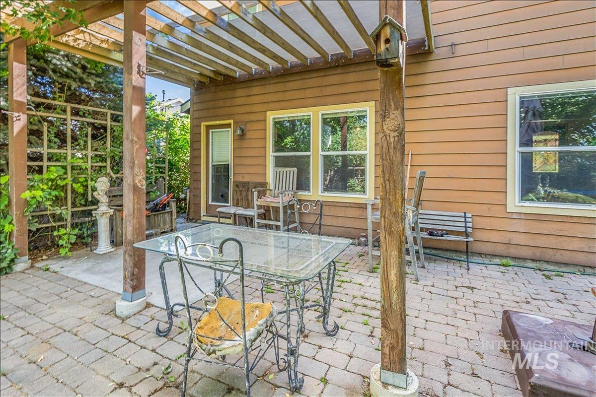 View of patio with outdoor dining area and a pergola