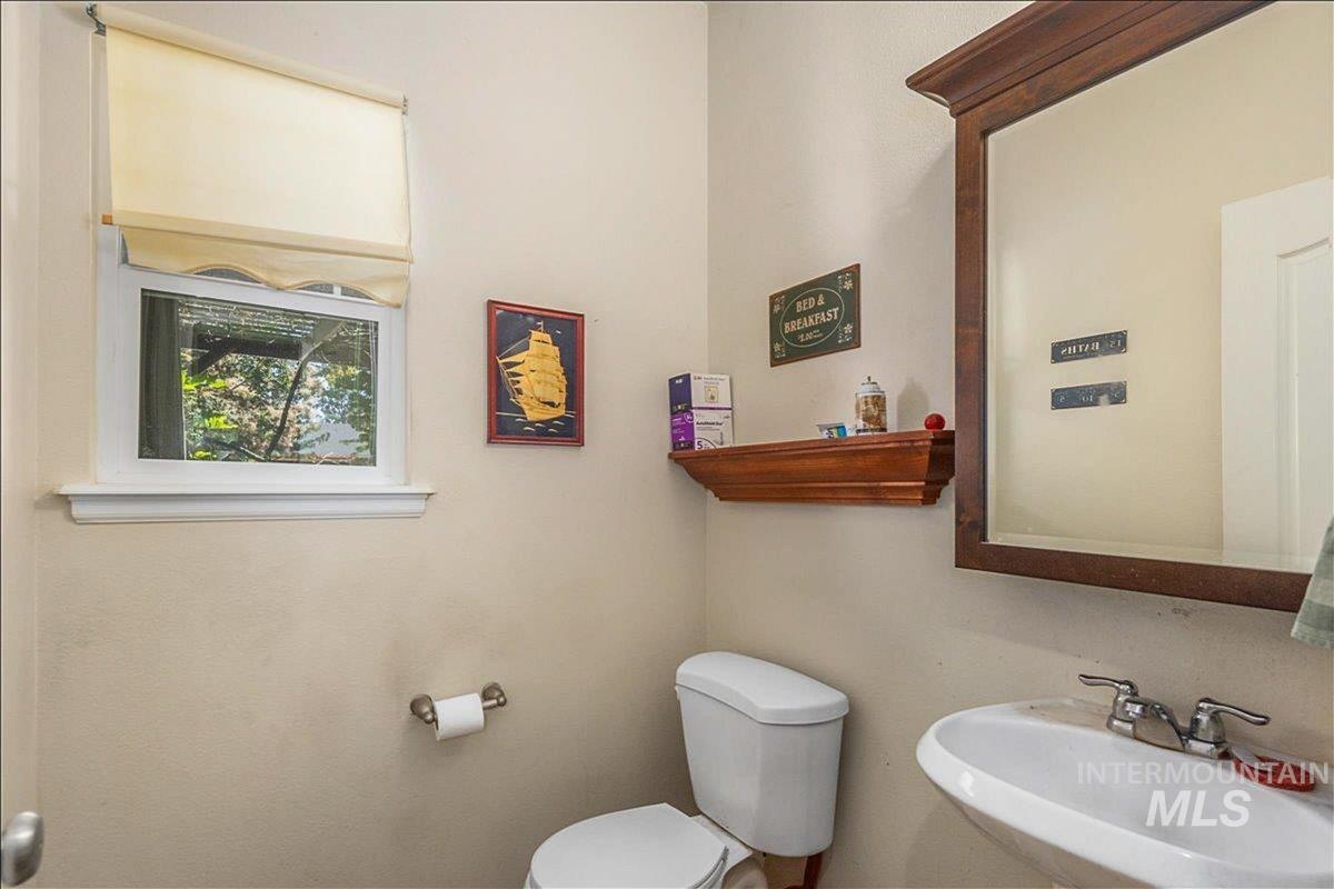 Half bathroom featuring a sink and toilet