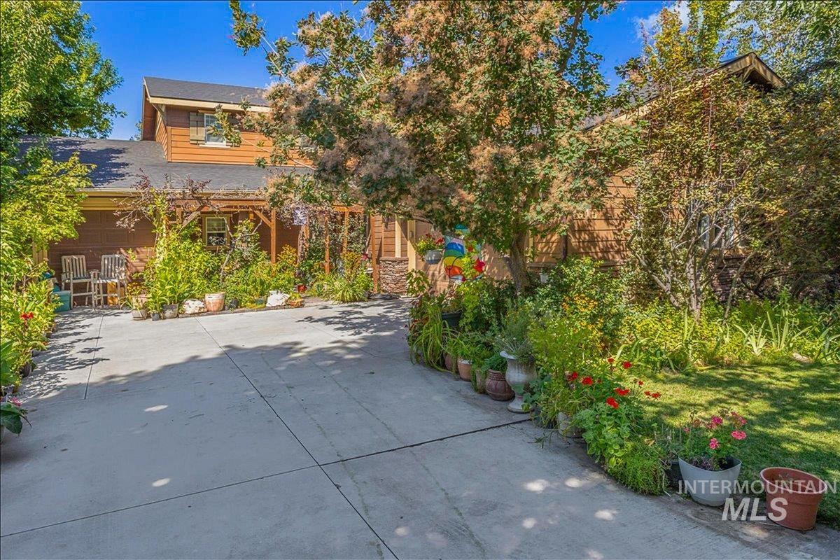 View of patio / terrace with concrete driveway and a garage