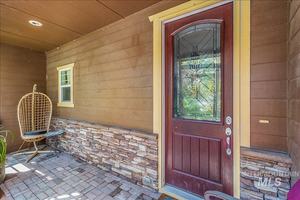 Entrance to property with stone siding
