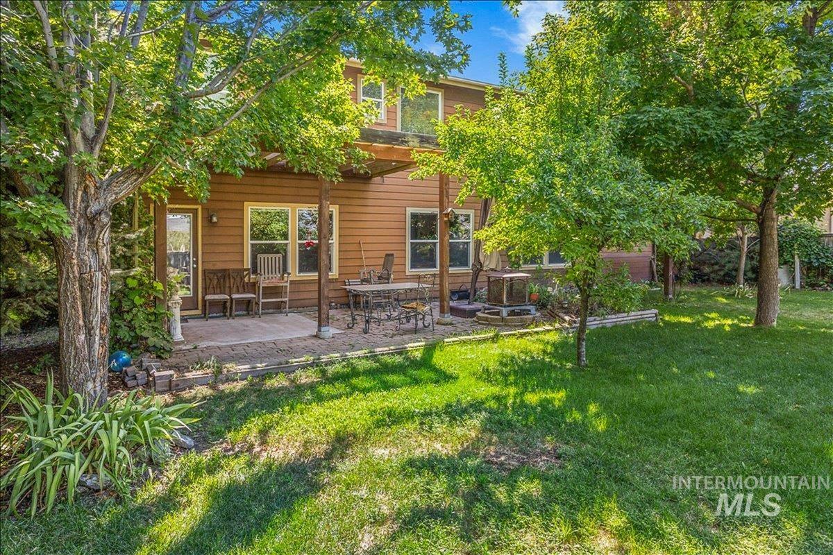 Rear view of property featuring a yard and a patio