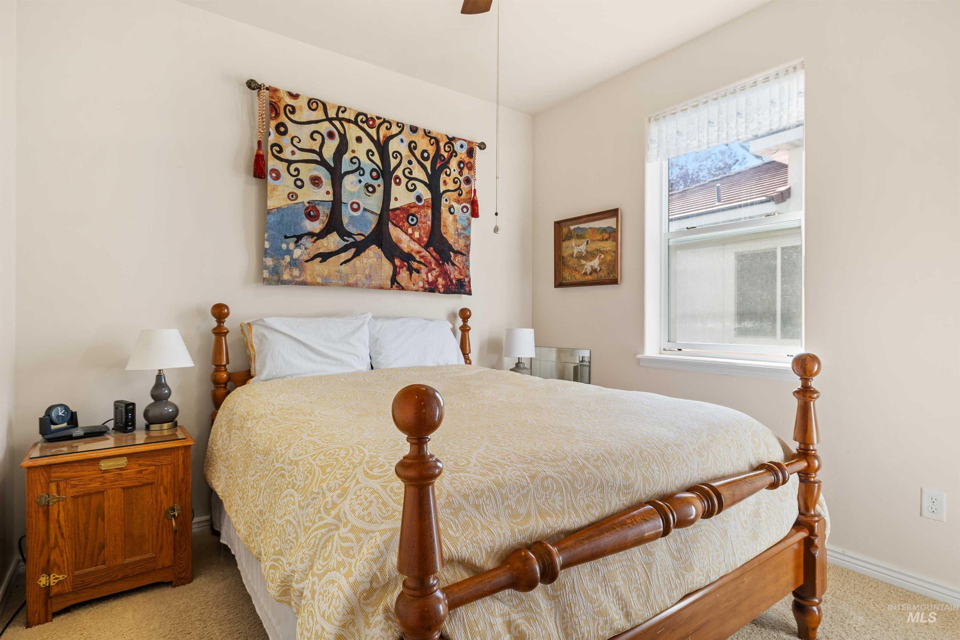Bedroom with light colored carpet and ceiling fan